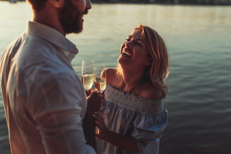 Lakeside date night couple with wine