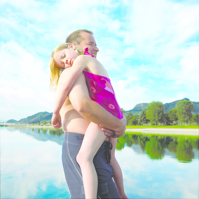 Father carries sleeping daughter on Osoyoos Lake