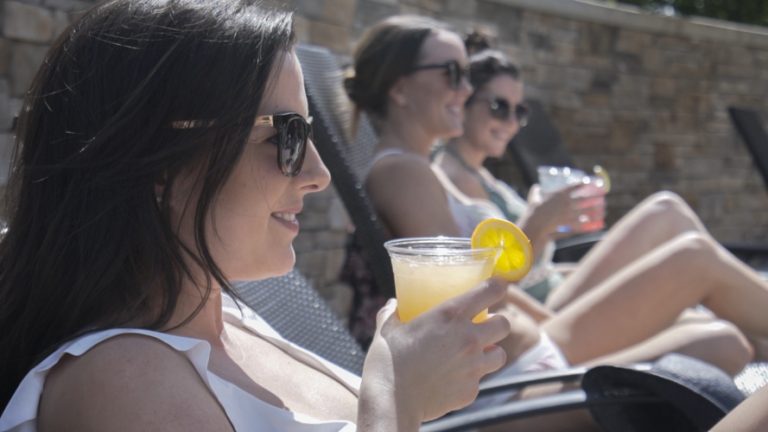 Girl with drinks by Watermark Resort pool