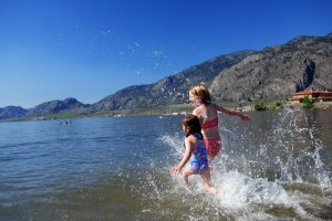 Girls play in Osoyoos Lake at Watermark Beach Resort