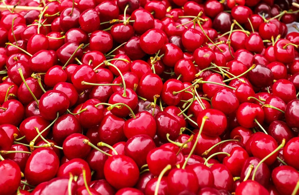 large pile of red cherries