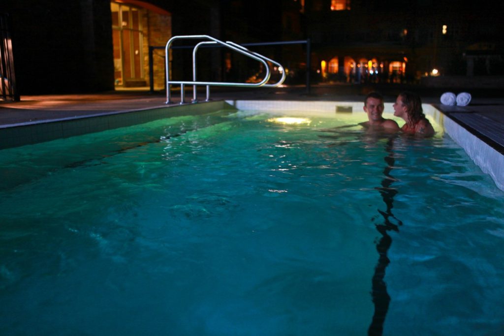 couple relaxing in hot tub at night