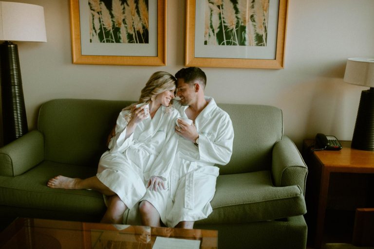 Romantic Couple embracing on couch in bathrobes at Watermark Beach Resort