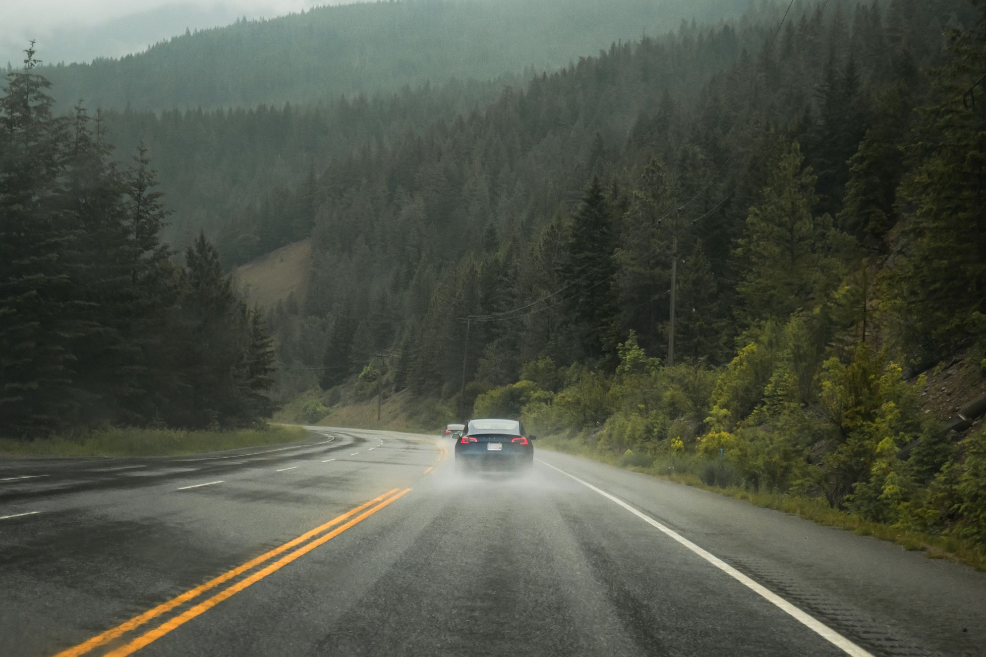 An electric vehicle travels down a BC highway.