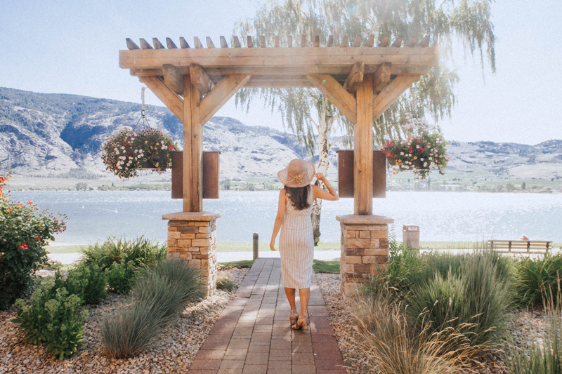 A woman taking a picture in front of Osoyoos Lake