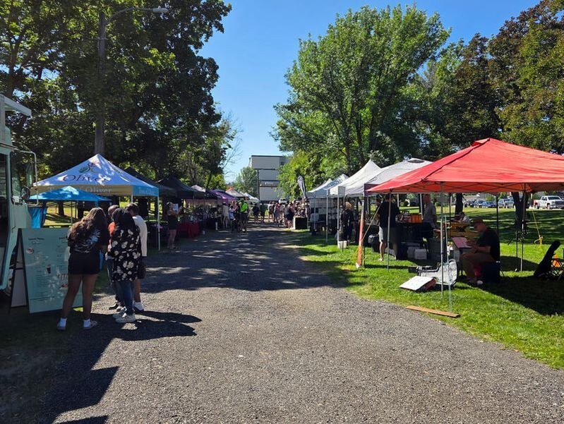 Vendor tents lining the path at Station Street Market in Oliver, BC