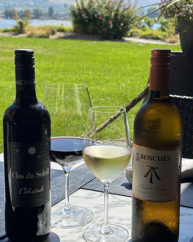 Clos du Soleil Célestiale and 3Benches Pinot Gris bottles with glasses on the 15 Park patio overlooking Osoyoos Lake