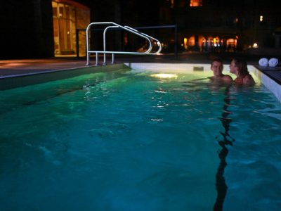 couple relaxing in hot tub at night