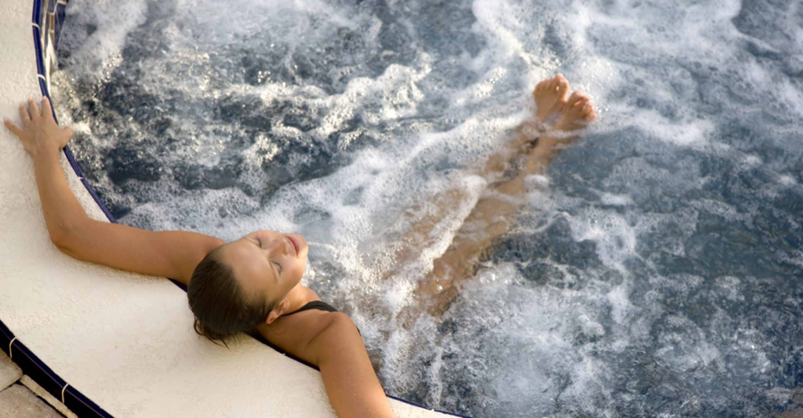 couple relaxing in hot tub at night